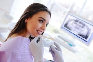 Young woman having dental teeth whitening in Long Beach, CA
